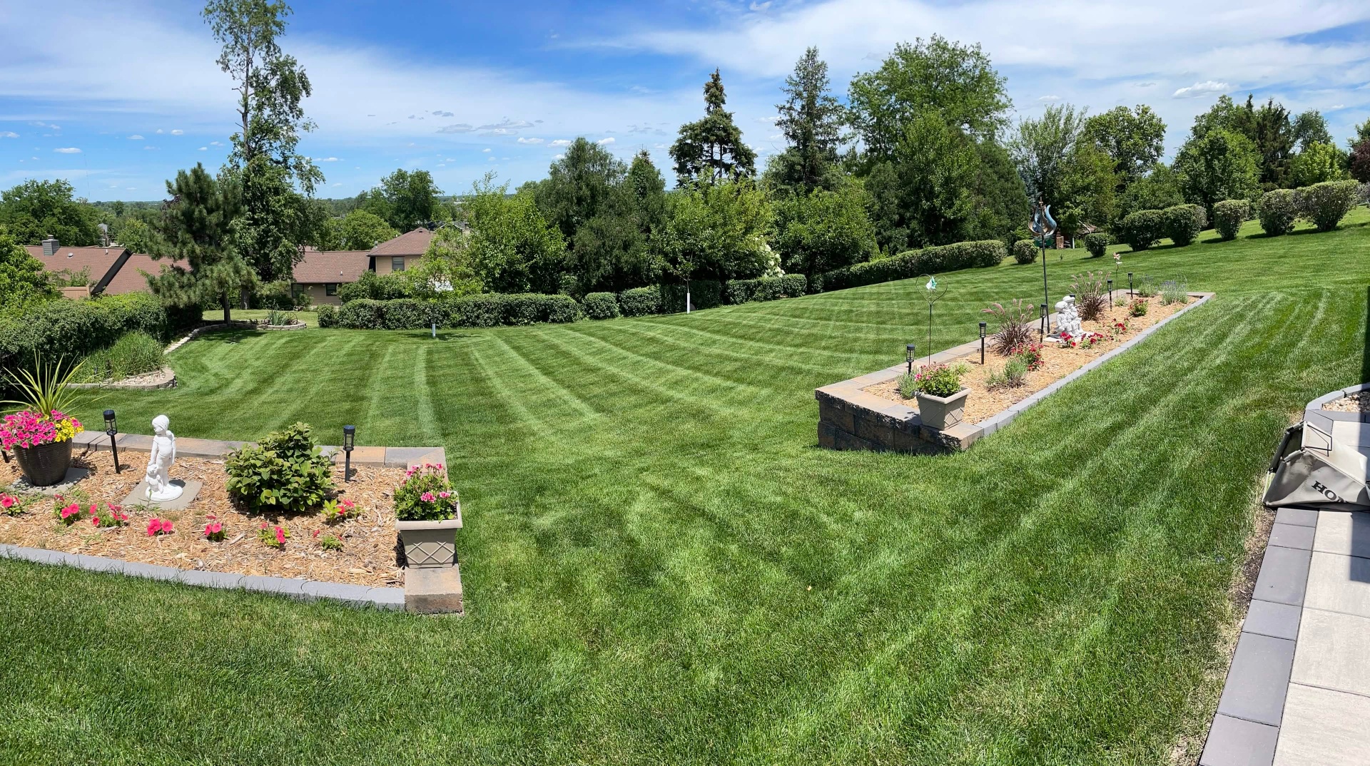 Hanzelka's Lawn Care professional mowing a residential property in Cedar Rapids